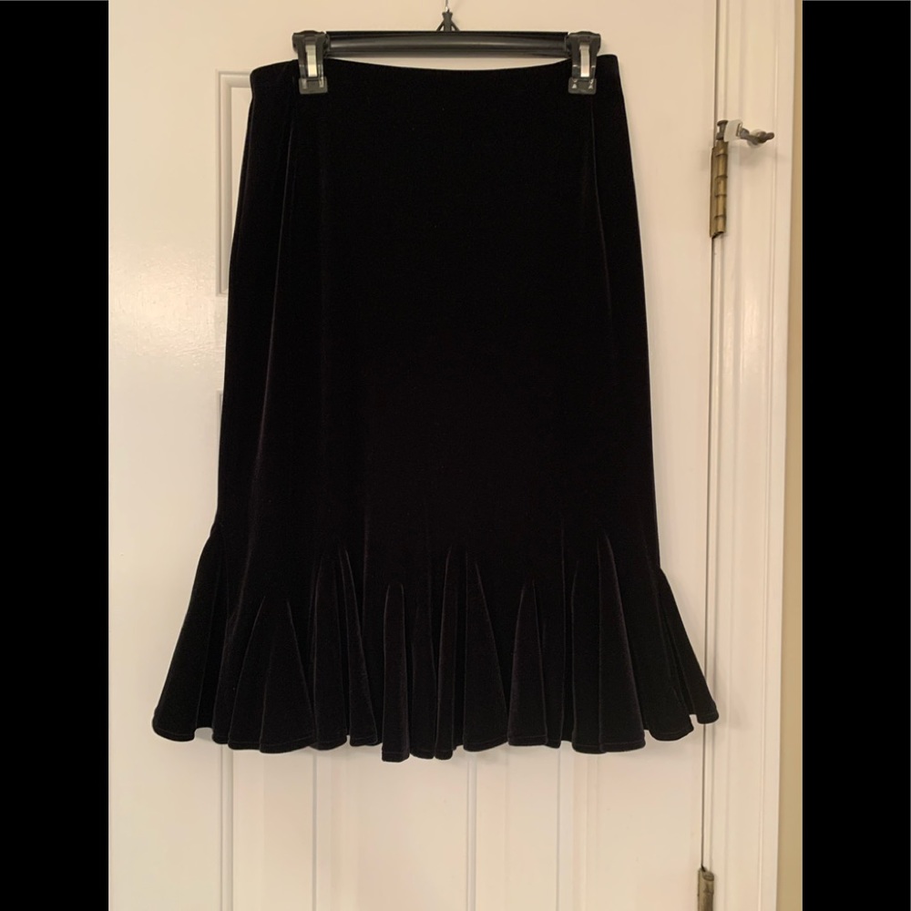 Cute black skirt, velvet fabric, with ruffled hem line.